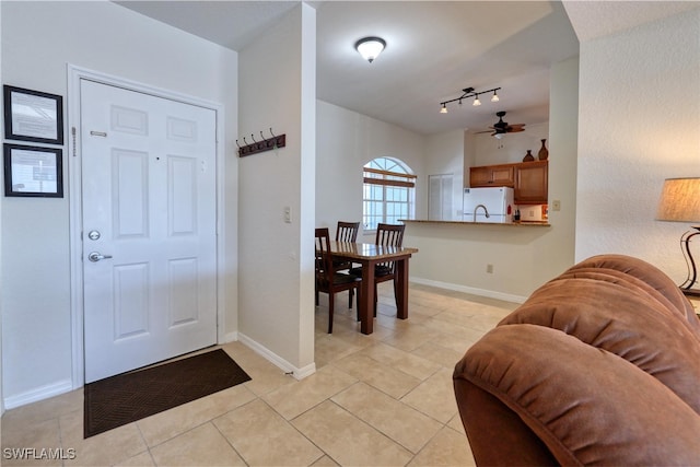 foyer featuring track lighting, ceiling fan, and light tile patterned flooring