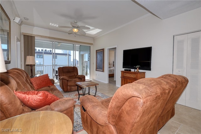 living room with ceiling fan, light tile patterned floors, and ornamental molding