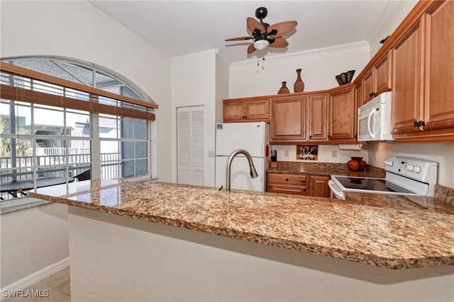 kitchen featuring kitchen peninsula, white appliances, light stone countertops, and ornamental molding