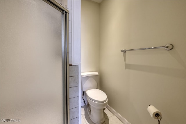 bathroom with walk in shower, tile patterned flooring, and toilet