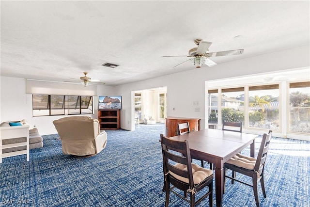 carpeted dining area with ceiling fan