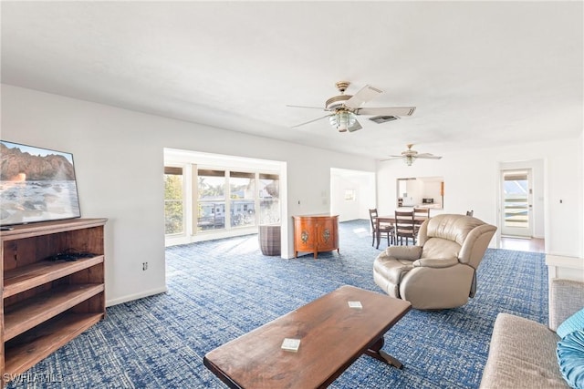 living room with carpet flooring and ceiling fan