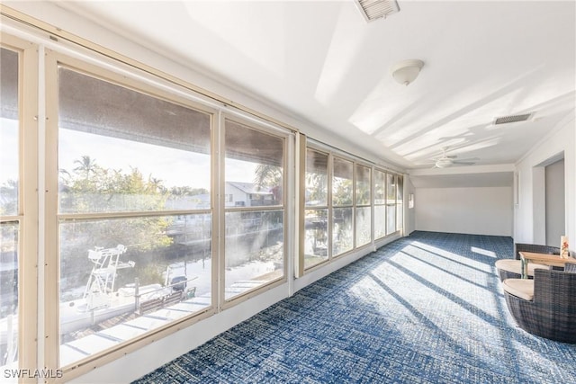 sunroom / solarium featuring ceiling fan