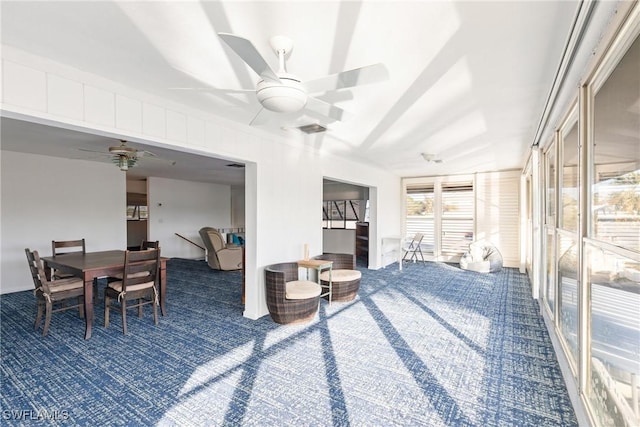 sunroom featuring ceiling fan