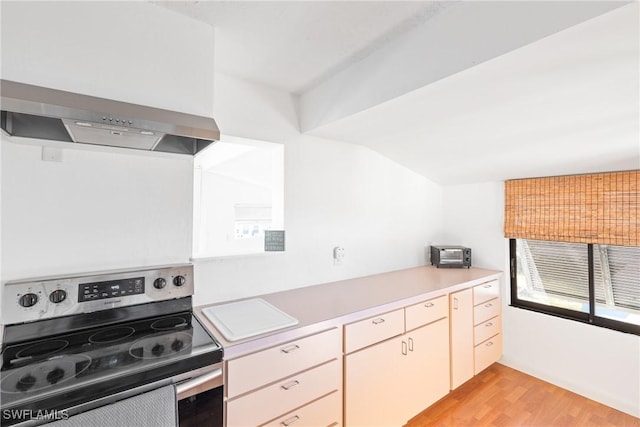 kitchen featuring light wood-type flooring, stainless steel electric range oven, and extractor fan