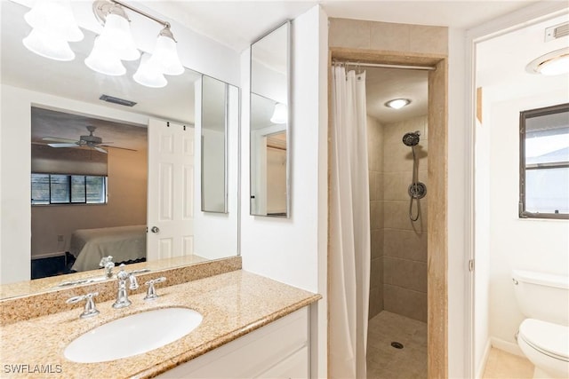 bathroom with a shower with curtain, ceiling fan, toilet, and vanity