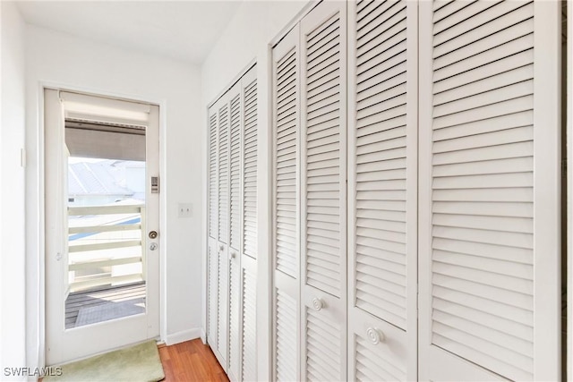 corridor featuring hardwood / wood-style floors