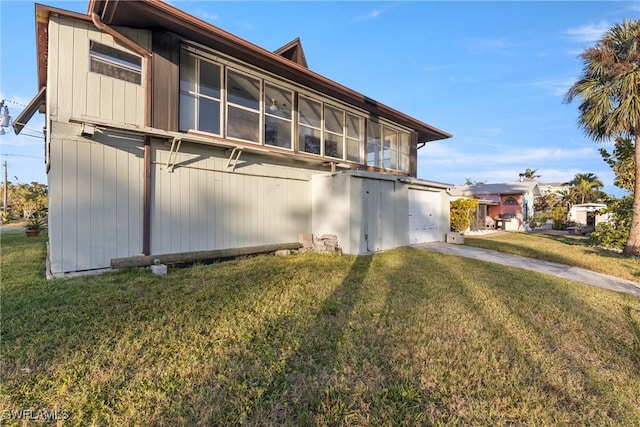 view of side of home featuring a yard and a garage