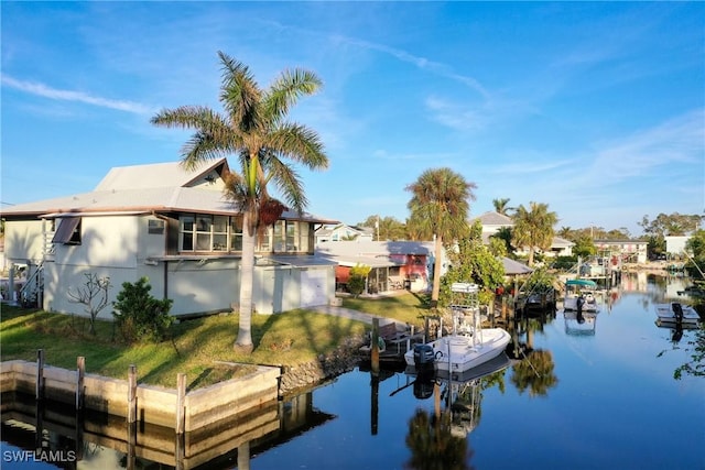 dock area featuring a water view and a yard