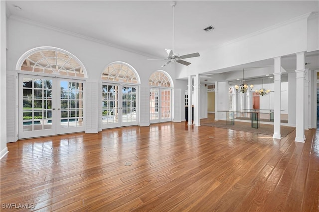 unfurnished living room with hardwood / wood-style flooring, plenty of natural light, and french doors