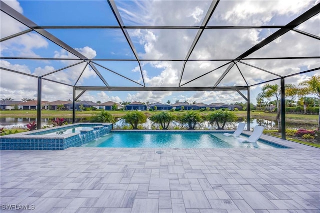 view of pool featuring glass enclosure, an in ground hot tub, a water view, and pool water feature