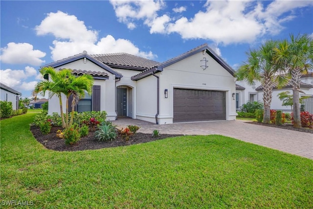 mediterranean / spanish home with a garage and a front yard