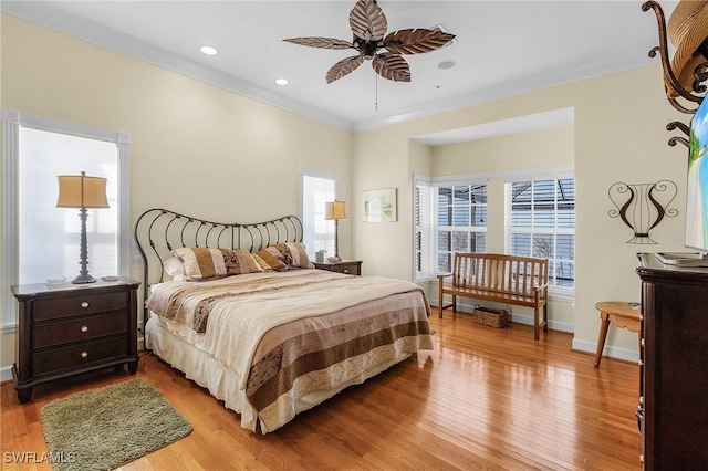 bedroom featuring ceiling fan, light wood-type flooring, and ornamental molding