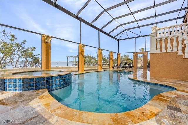 view of swimming pool with a water view, pool water feature, a lanai, an in ground hot tub, and a patio