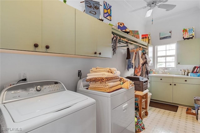 laundry room with ceiling fan, washer and clothes dryer, cabinets, and sink