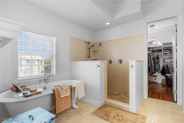 bathroom with wood-type flooring and shower with separate bathtub