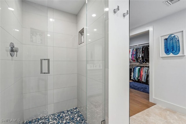 bathroom featuring hardwood / wood-style floors and an enclosed shower