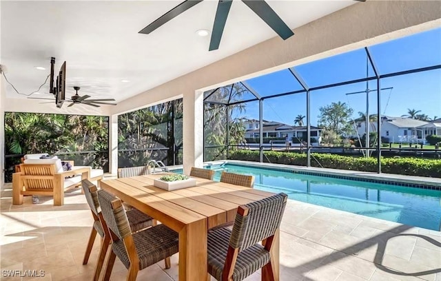 view of pool featuring ceiling fan, a patio, and glass enclosure