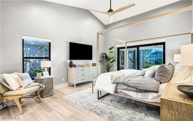 bedroom with high vaulted ceiling, access to outside, light hardwood / wood-style flooring, and ceiling fan