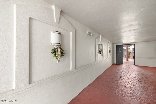 corridor featuring a textured ceiling