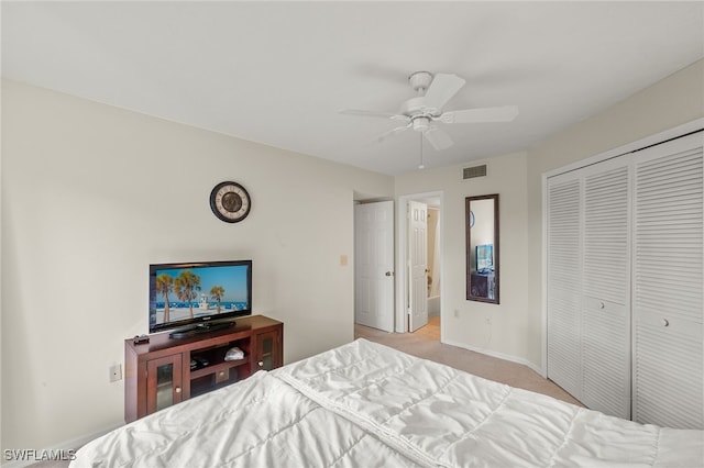 carpeted bedroom featuring ceiling fan and a closet