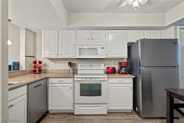 kitchen featuring ceiling fan, white cabinets, stainless steel appliances, and light wood-type flooring