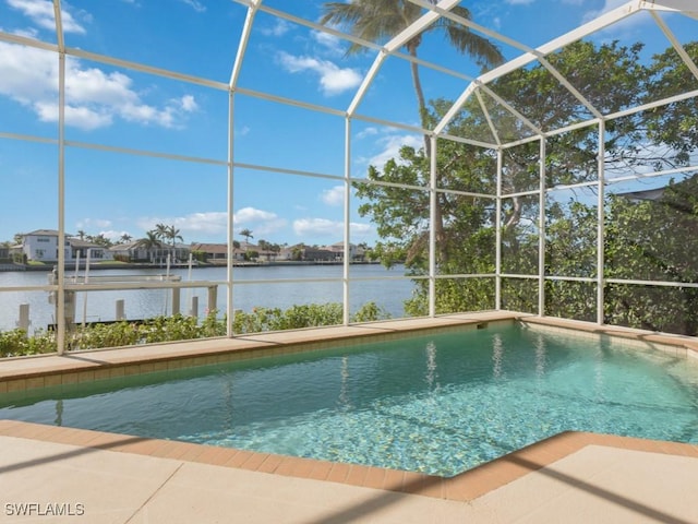 view of swimming pool with a lanai and a water view