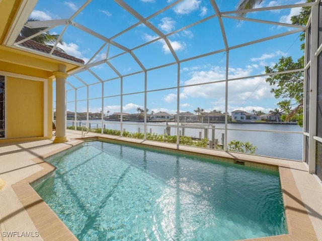 view of swimming pool featuring a water view, a patio area, and a lanai