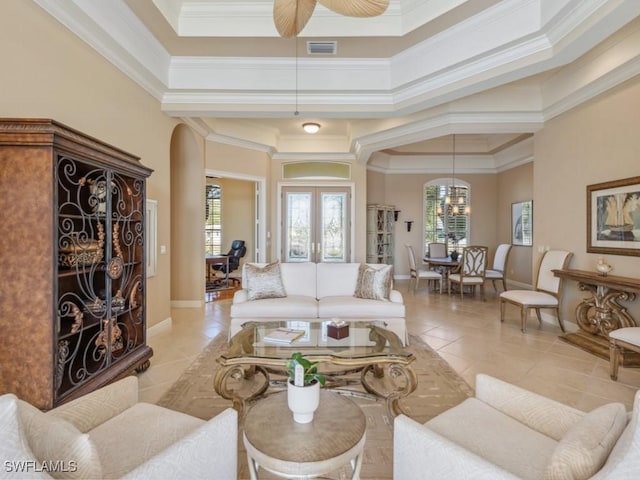 living room featuring light tile patterned floors, french doors, ceiling fan, and a healthy amount of sunlight