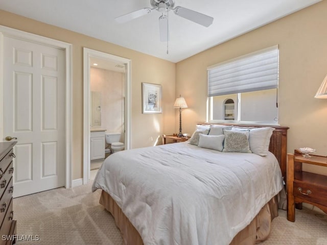 carpeted bedroom featuring connected bathroom and ceiling fan