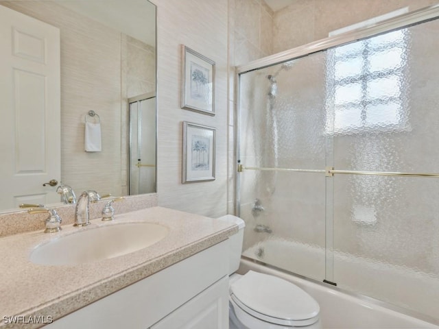 full bathroom with toilet, combined bath / shower with glass door, and vanity