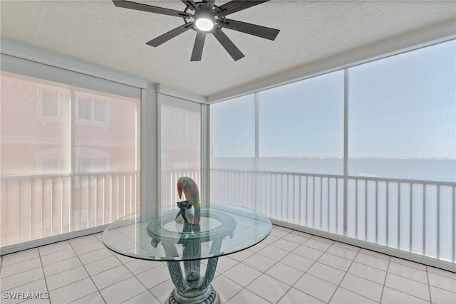 sunroom featuring ceiling fan and a healthy amount of sunlight