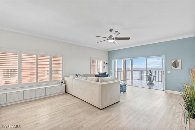 living room with light wood-type flooring, ceiling fan, and crown molding