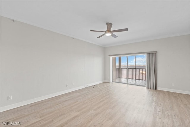 spare room featuring ceiling fan, ornamental molding, and light wood-type flooring