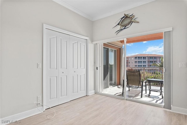 interior space with light wood-type flooring and ornamental molding