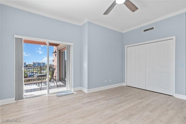 unfurnished bedroom featuring access to exterior, ceiling fan, crown molding, light hardwood / wood-style flooring, and a closet