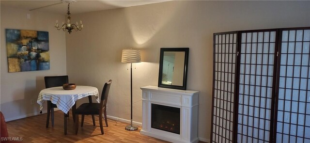 dining area featuring hardwood / wood-style flooring and an inviting chandelier