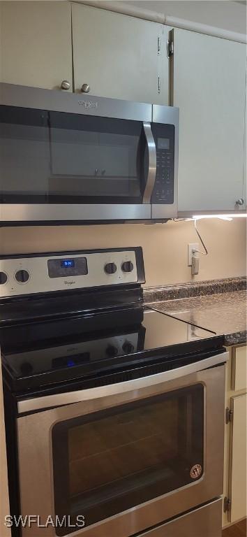 kitchen featuring stainless steel appliances and white cabinets