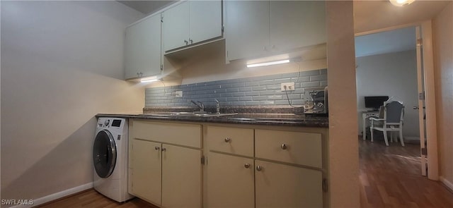 kitchen featuring washer / dryer, sink, tasteful backsplash, white cabinetry, and dark hardwood / wood-style floors