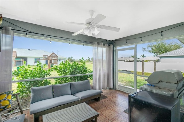 sunroom / solarium featuring ceiling fan and a healthy amount of sunlight