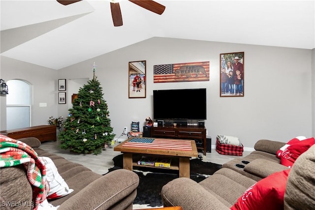 living room featuring ceiling fan and vaulted ceiling