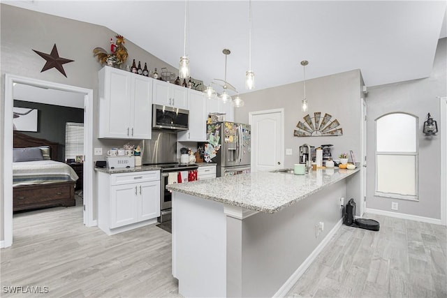 kitchen with white cabinetry, lofted ceiling, sink, and appliances with stainless steel finishes