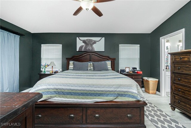 bedroom with ceiling fan, light hardwood / wood-style flooring, and ensuite bath