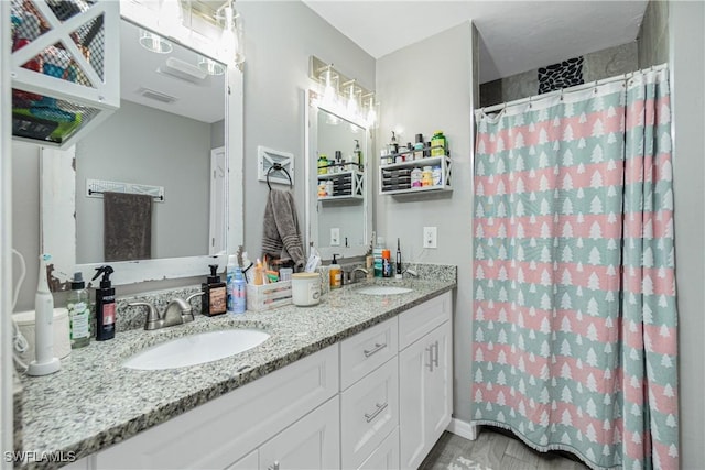 bathroom with a shower with curtain and vanity