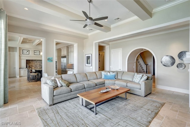 living room with crown molding, a fireplace, beamed ceiling, and ceiling fan