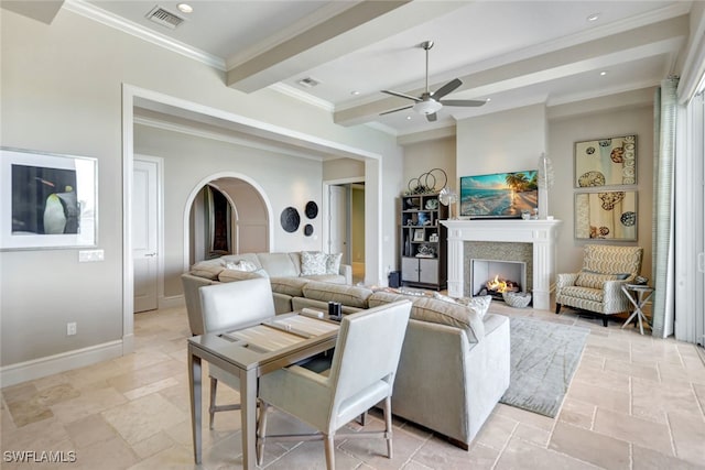 living room with ceiling fan, beamed ceiling, and ornamental molding