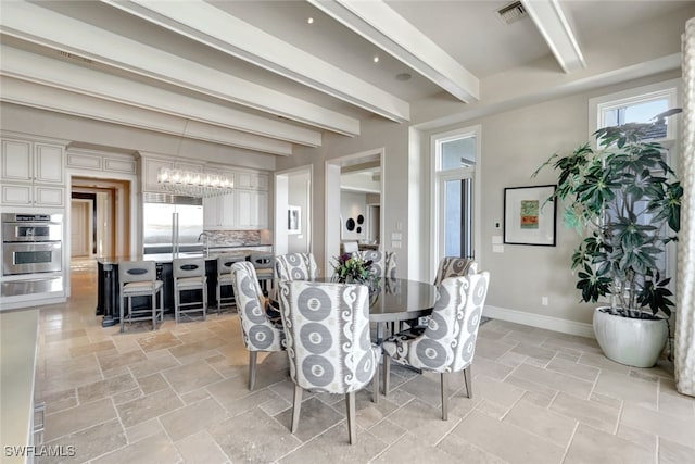 dining room with beamed ceiling and a notable chandelier