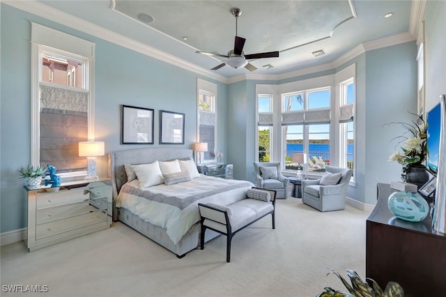 carpeted bedroom featuring ceiling fan, a water view, and crown molding