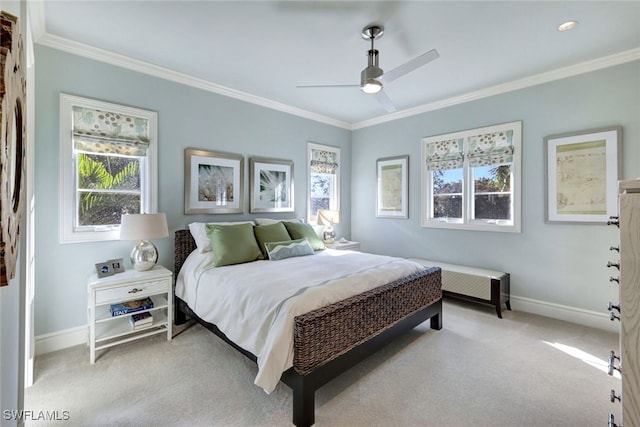 carpeted bedroom featuring ceiling fan and crown molding