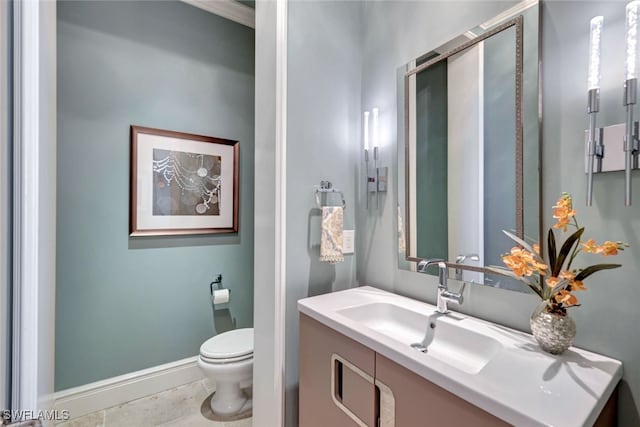 bathroom featuring tile patterned floors, vanity, and toilet